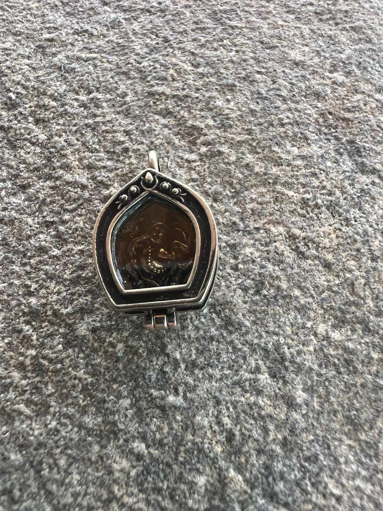 Tiny Dzambhala Ghau Pendant | Metal and Glass | Approx 3/4in x 1/2in | Tibet | Gau - The Incense Stick