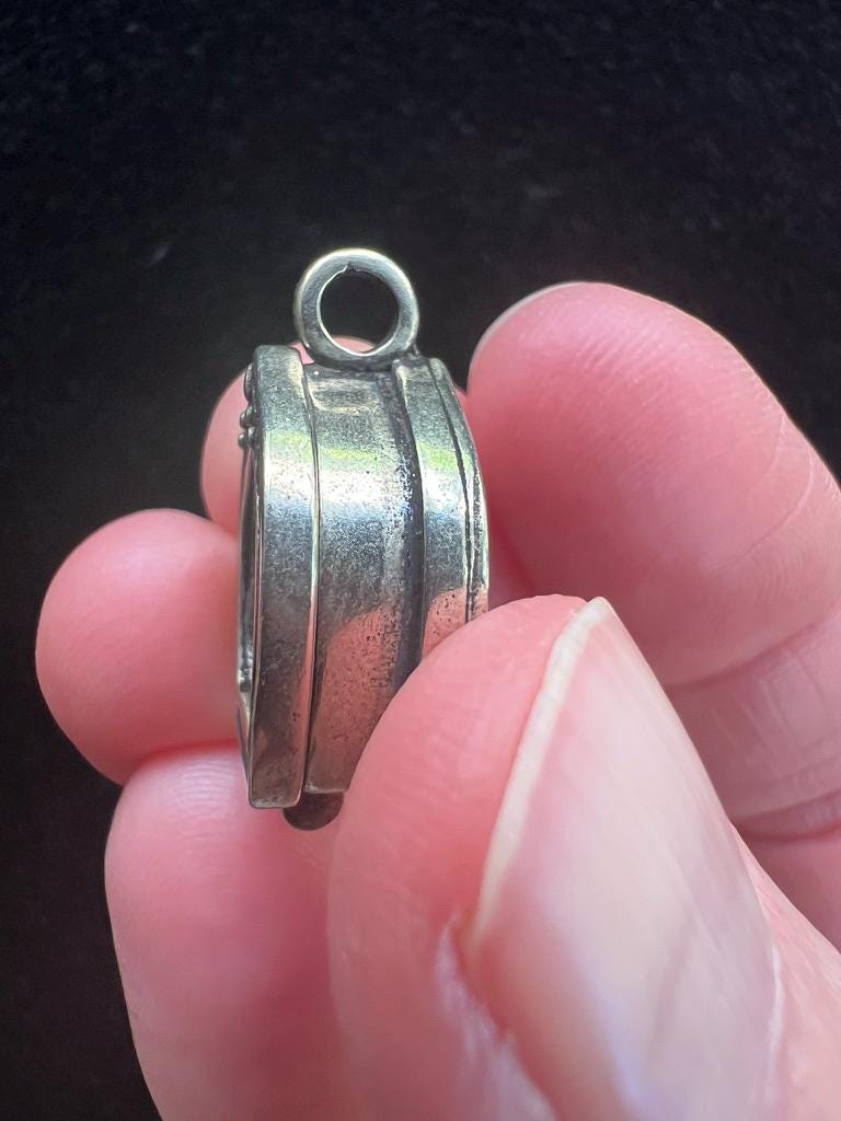 Tiny Dzambhala Ghau Pendant | Metal and Glass | Approx 3/4in x 1/2in | Tibet | Gau - The Incense Stick