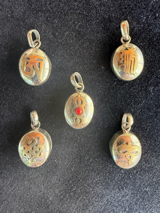 Small Ghau Charm | Brass | Nepal | Aprox. 3/4 in by 1/2 in | Assorted Designs - The Incense Stick